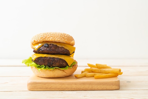 hamburger or beef burgers with cheese and french fries - unhealthy food style