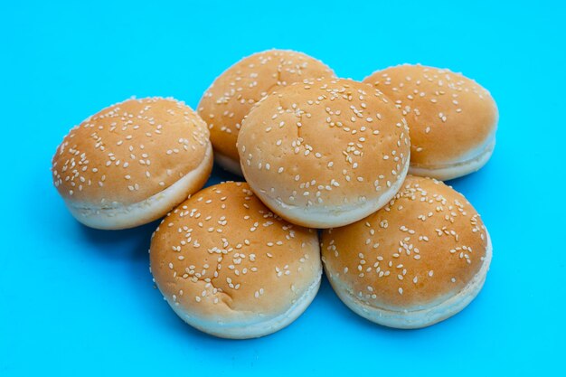 Hamburger buns with sesame on blue background