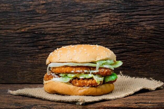 Hamburger a chicken on a wooden