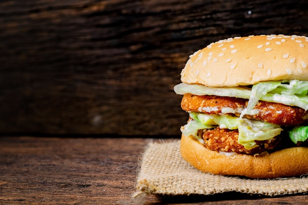 Hamburger a chicken on a wooden