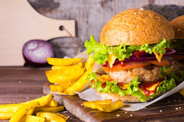 Hamburger and french fries on a wooden table