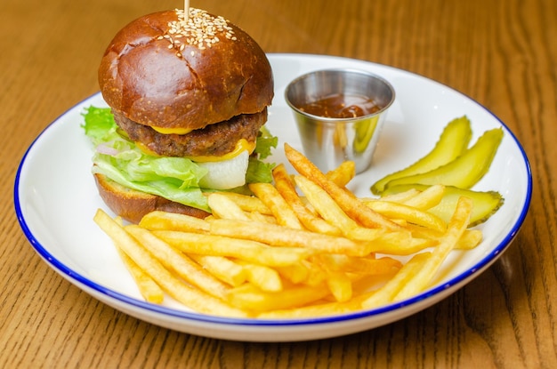 hamburger, fries and sauce in a plate