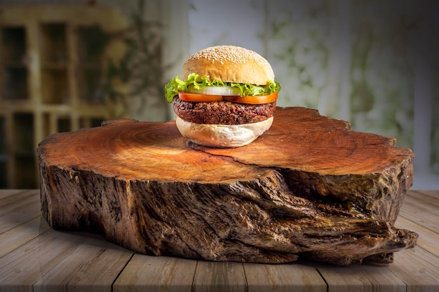 hamburger on a log with a tree stump in the background