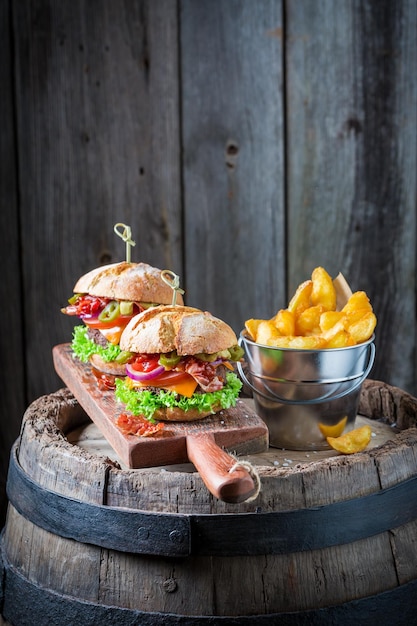 Hamburger made of lettuce beef and cheese on wooden board