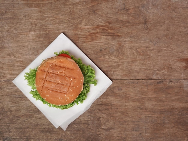 A hamburger on a plate with lettuce on it