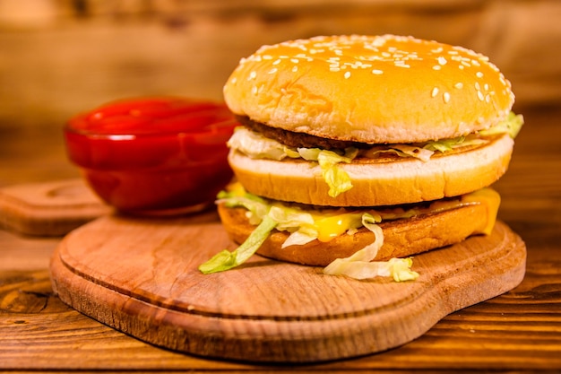 Hamburger and sauce on a wooden table