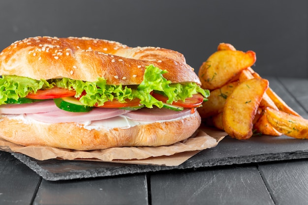 Hamburger with fries on a slate plate