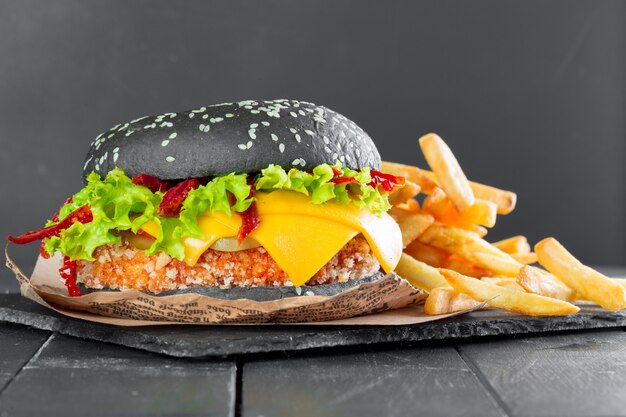 Hamburger with fries on a slate plate