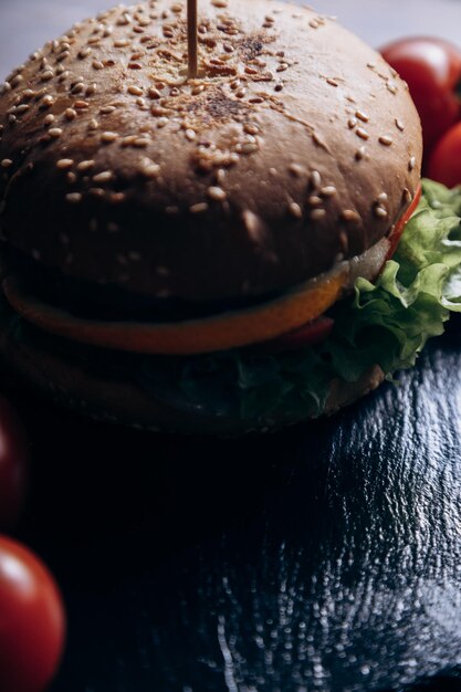 A hamburger with lettuce and tomato on a table