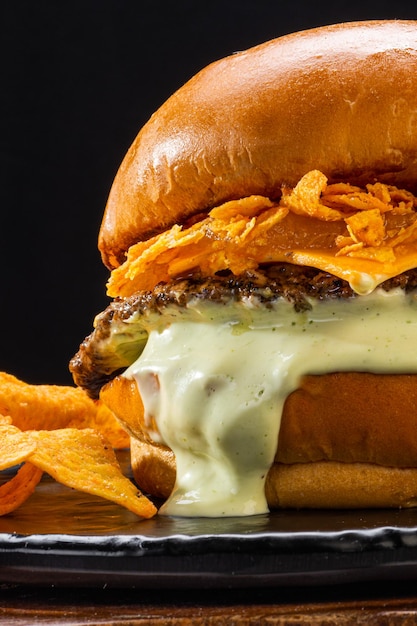 Hamburger with meat melted cheese potato chips and mayonnaise