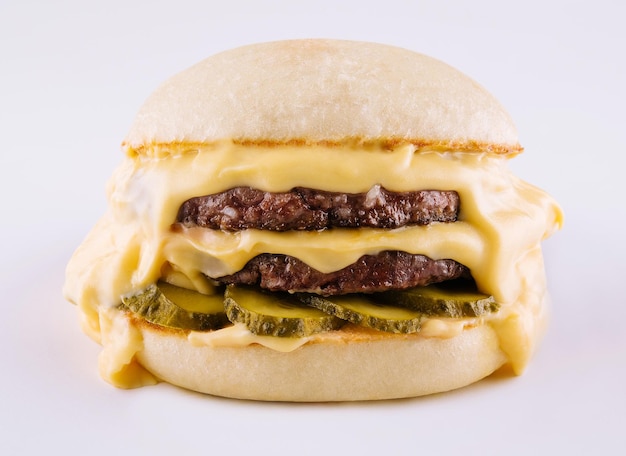 Hamburger with two cutlets pickled cucumbers and melted cheese