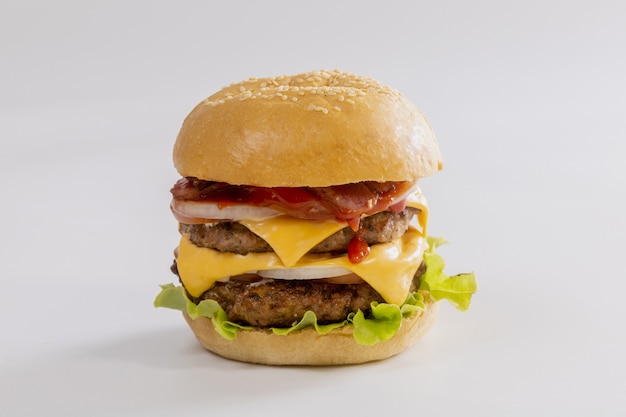 Hamburger with vegetables and cheese on white background