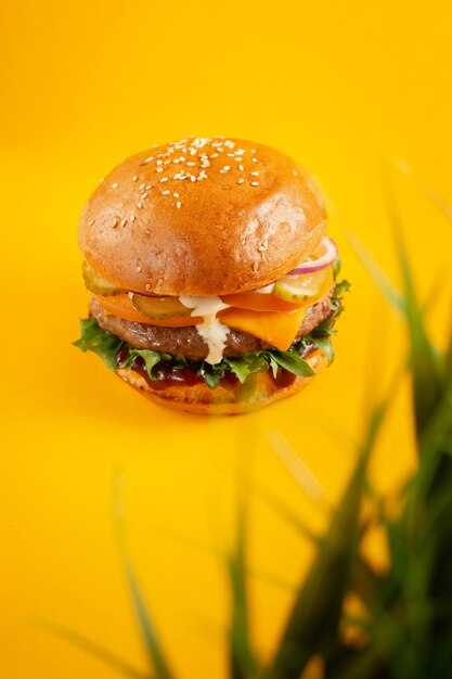 Hamburger on a yellow background. fast food, junk food concept