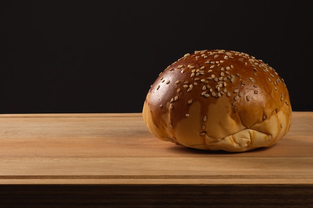 Hamburgerbrood op basis van hout en zwarte achtergrond.