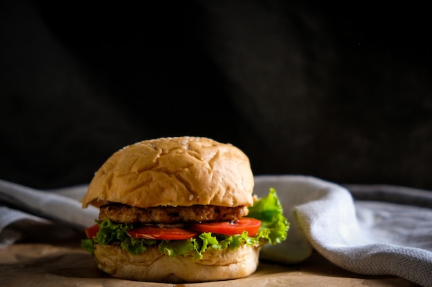 Hamburgers met kaas, salades en groenten op een zwarte ruimte