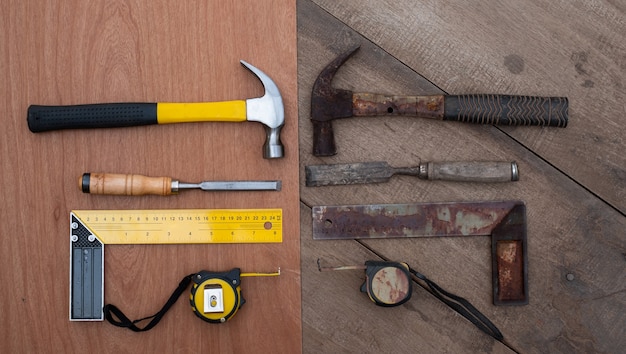 Hamer chisel Tape measure Ruler Collection of old and new woodworking handtools on a rough workbench wooden