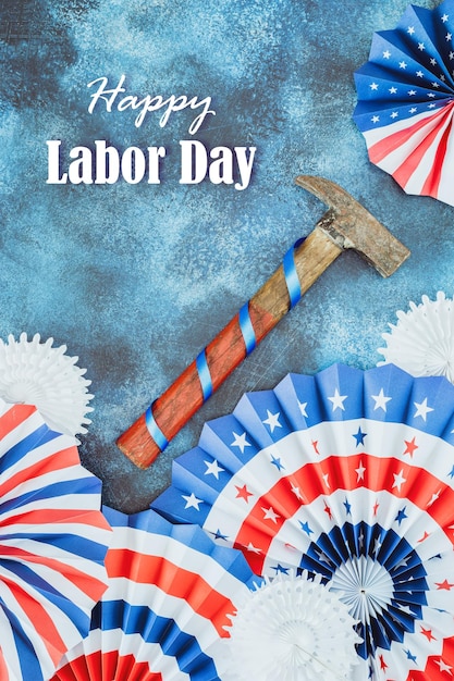 Photo hammer and american flag colors holiday decor on a blue background with inscription happy labor day
