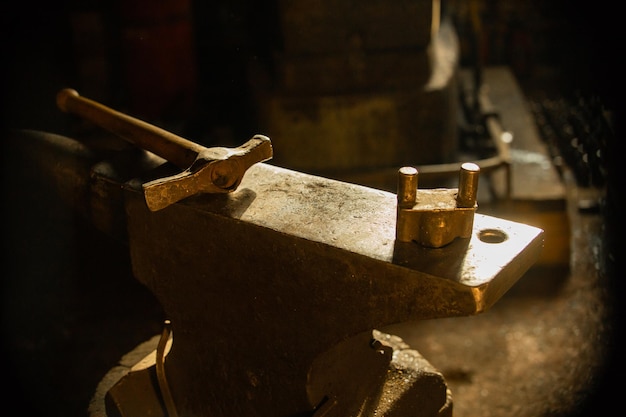 A hammer on the anvil in natural sun lighting indoors