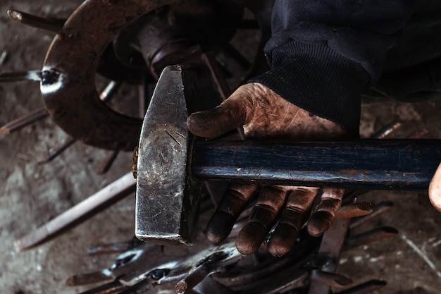 Hammer in dirty male hand.