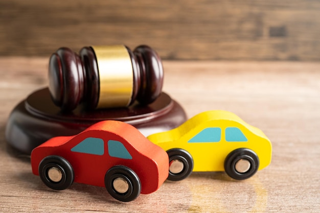 Hammer gavel judge with car vehicle accident insurance coverage claim lawsuit court case