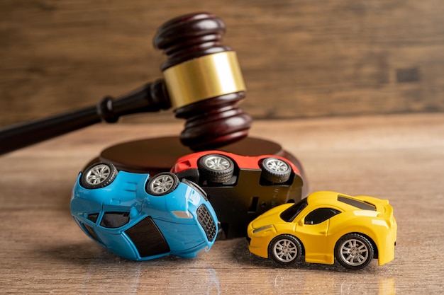Photo hammer gavel judge with car vehicle accident insurance coverage claim lawsuit court case