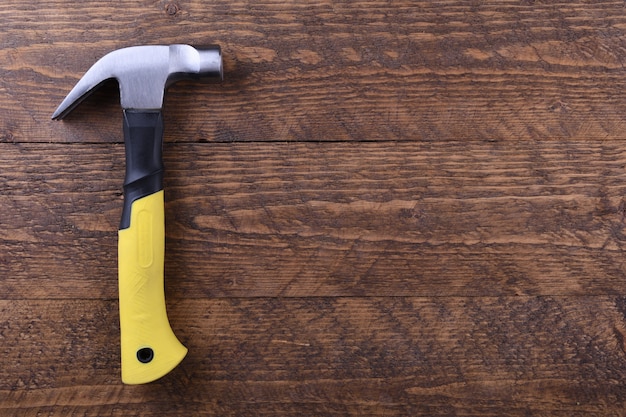 Hammer iron on wooden table