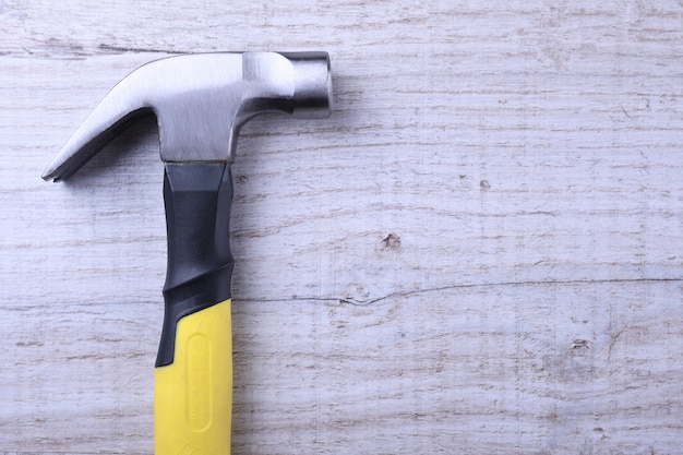 Hammer iron on wooden table