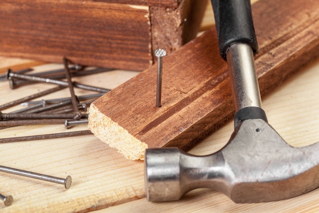 Hammer and nails on wood 