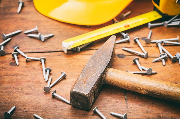 Hammer and nails on wooden background