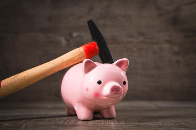 Hammer and piggy bank on the table