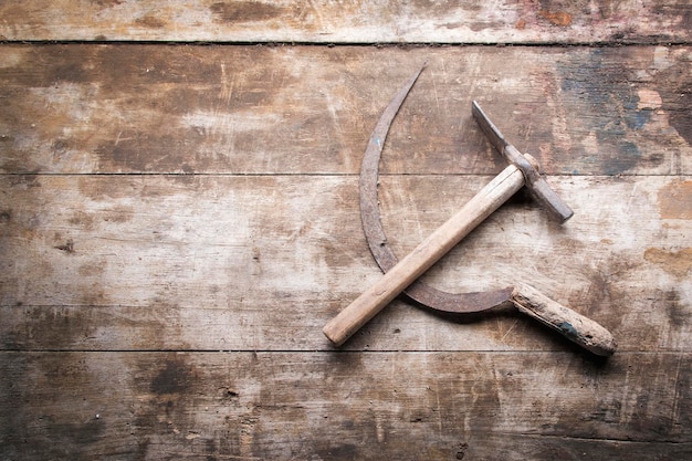 Hammer and sickle stacked in the form of the coat of arms of the USSR on a table