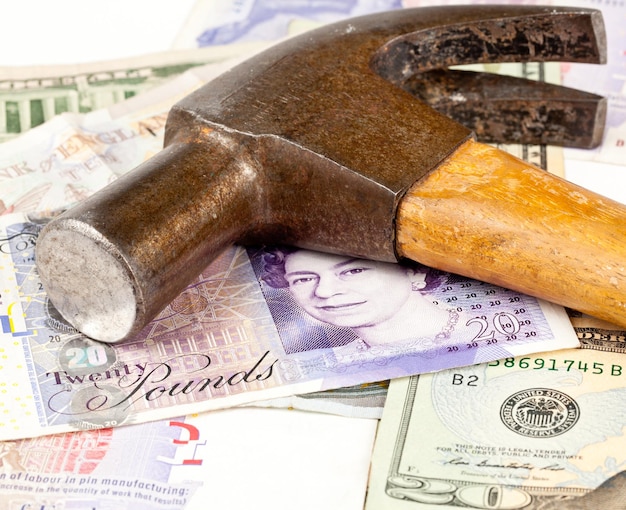 Hammer on top of pound note