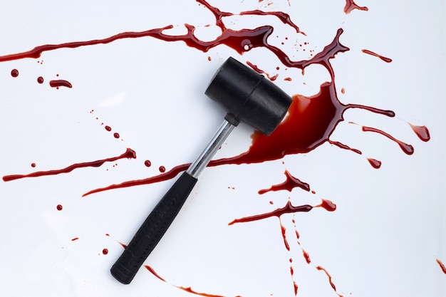 Hammer with blood on white background.