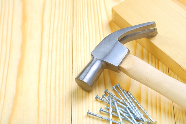 Hammer with nails and plank