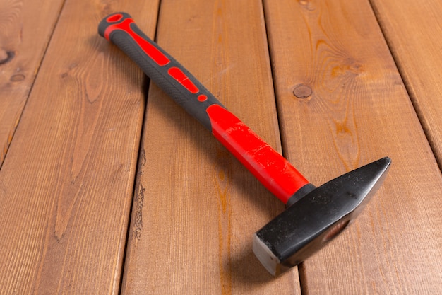 Hammer on wooden surface. Top view