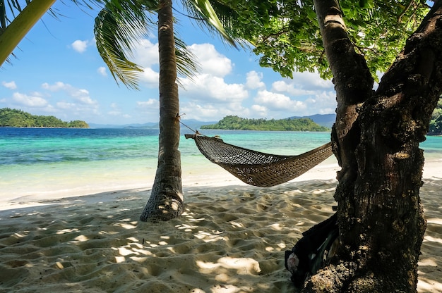 The hammock on Paradise island on sea background in the Philippines