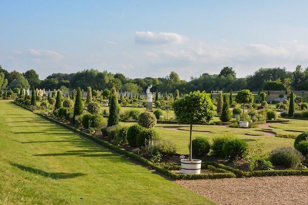 Hampton Court Palace, Brick, England, Lawn, Public Park. LONDON, UK - JULY 21, 2014: Hampton Court was originally built for Cardinal Thomas Wolsey, a favorite of King Henry VIII, circa 1514.