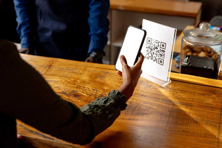 Photo hand of african american woman scanning qr code using smartphone in cafe. lifestyle, coffee, communication and local business, unaltered.