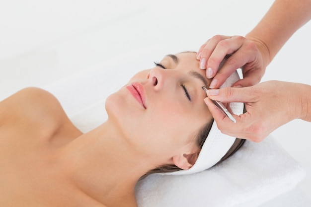 Hand applying eyeshadow to beautiful woman