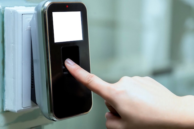 the hand are scanning on fingerprint machine for enter digital security door system