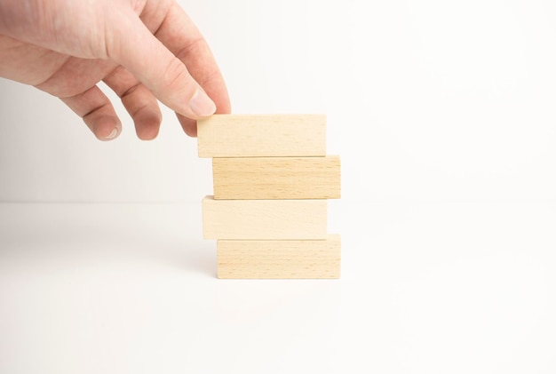 Hand arranging wood block stacking as step stair. Business concept for growth success process