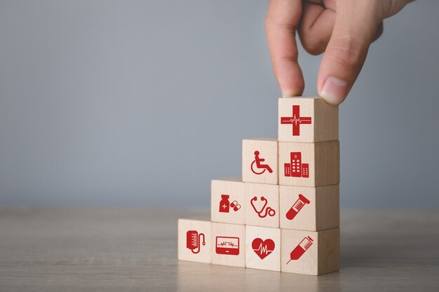 Hand arranging wood block stacking with icons