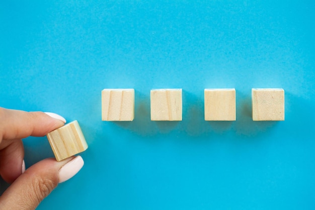 Hand arranging wood block with empty space