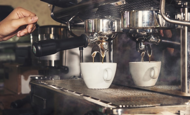 Hand of Barista making Coffee with coffee machine in the coffee shop