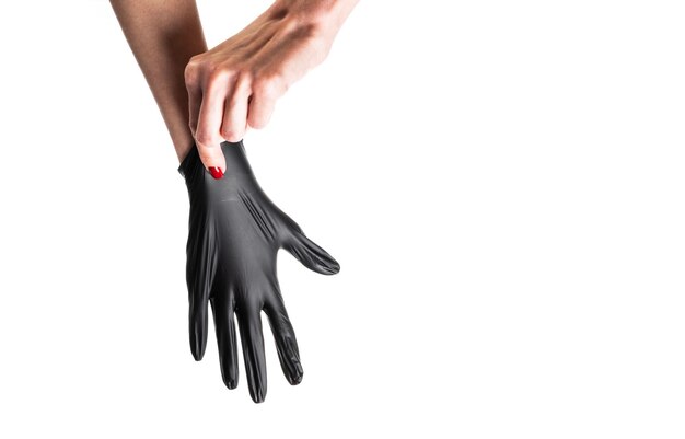 Hand in black gloves of a doctor or hairdresser on a white background