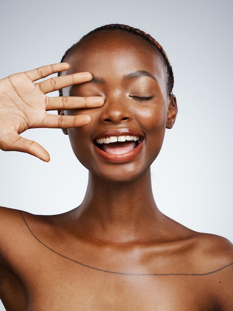 hand of black woman smile or natural beauty aesthetic for wellness in studio with pride shine or glow dermatology clean face or happy african girl model with skincare results on white background
