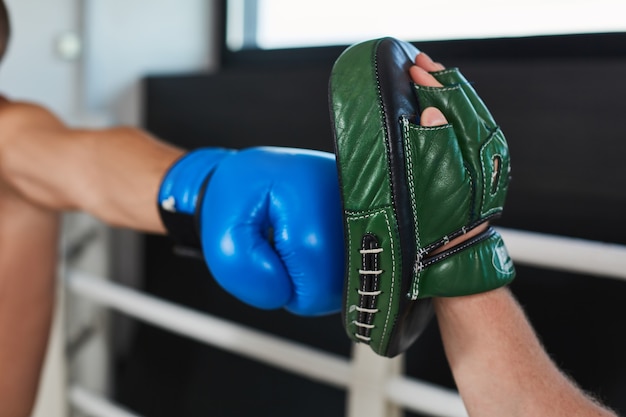 Hand of boxer and training gloves