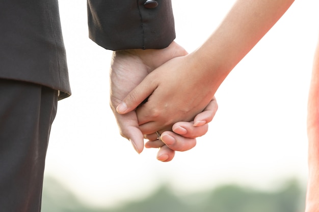 The hand of the bride and groom Holding hands