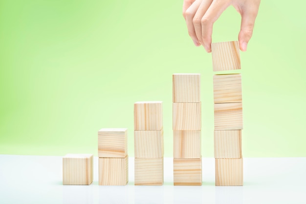 Hand build stairs of wooden block toy on the table