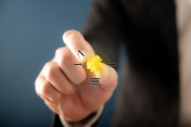 Hand of a businessman creating a light bulb icon a virtual interface